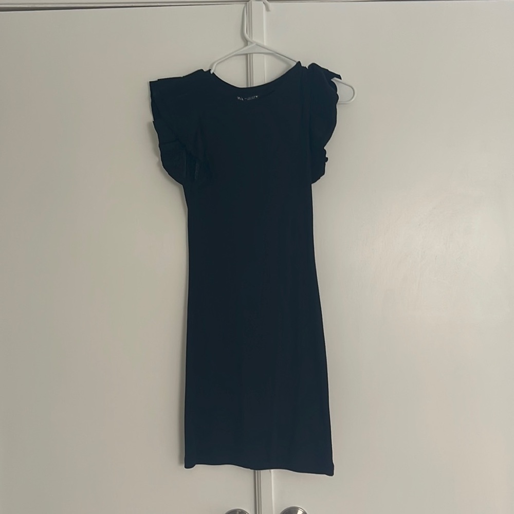 ADORABLE black little dress with a ruffle in the sleeve!!
